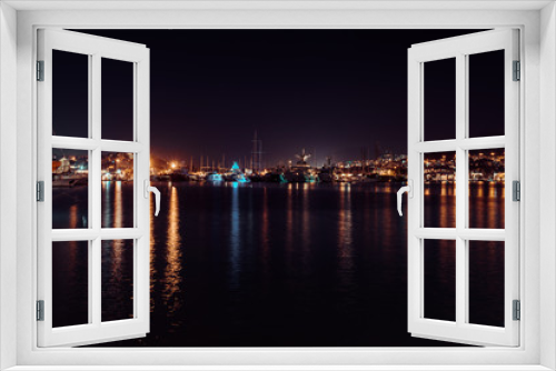 Fototapeta Naklejka Na Ścianę Okno 3D - Night view of port of Bodrum. Lights of the city and reflection in water, Bodrum, Turkey