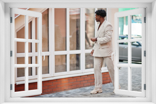 Stylish afro man in beige old school suit. Fashionable young African male in casual jacket on bare torso.