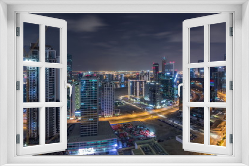 Fototapeta Naklejka Na Ścianę Okno 3D - Aerial view of illuminated buildings and high traffic in modern Dubai city, United Arab Emirates Timelapse Aerial