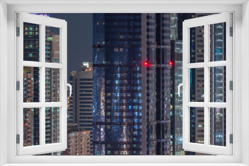 Fototapeta Naklejka Na Ścianę Okno 3D - Dubai International Financial Centre district with modern skyscrapers night timelapse