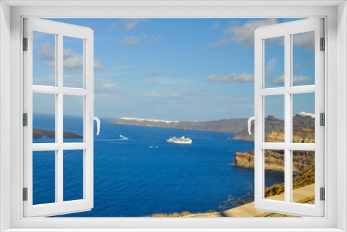 Fototapeta Naklejka Na Ścianę Okno 3D - A cruise liner is sailing to the island with the volcano on Santorini