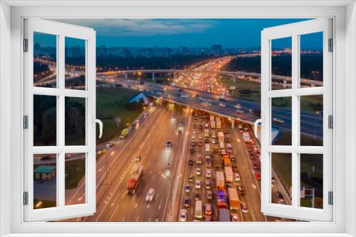 Fototapeta Naklejka Na Ścianę Okno 3D - View from the air on the movement of cars on the overpasses at the intersection with the ring road and the exit from the city
