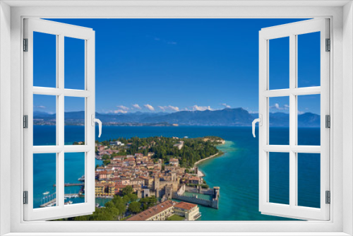 Fototapeta Naklejka Na Ścianę Okno 3D - Unique view. Aerial photography, the city of Sirmione on Lake Garda north of Italy. In the background is the Alps. Resort place. Aerial view. 