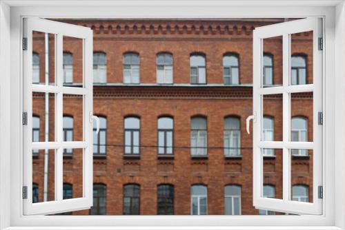 Fototapeta Naklejka Na Ścianę Okno 3D - Panorama of the facade of an old brick apartment building as a background
