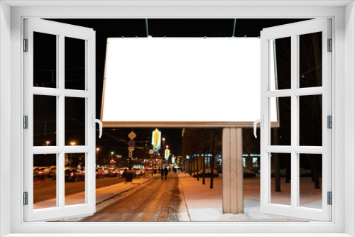Fototapeta Naklejka Na Ścianę Okno 3D - advertising billboard in the city at night in winter. Ad design mockup with white field. near the road