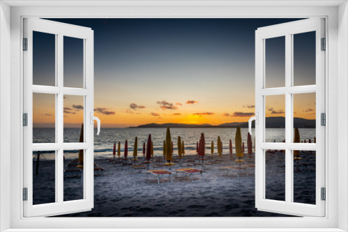 Fototapeta Naklejka Na Ścianę Okno 3D - Beach chairs and parasols under a clear sky at sunset