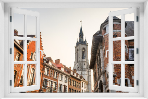 Fototapeta Naklejka Na Ścianę Okno 3D - Tall medieval bell tower rising over the street with old european houses, Tournai, Walloon municipality, Belgium