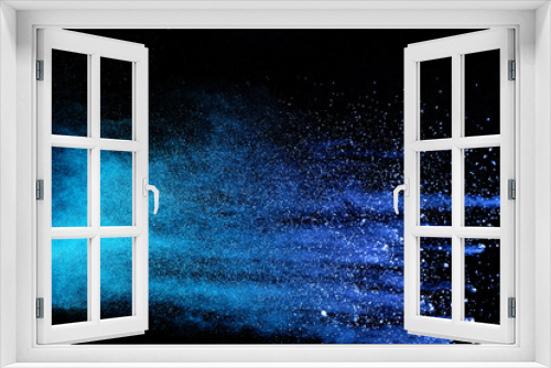 Fototapeta Naklejka Na Ścianę Okno 3D - Abstract brown powder explosion. Closeup of blue dust particle splash isolated on black background.