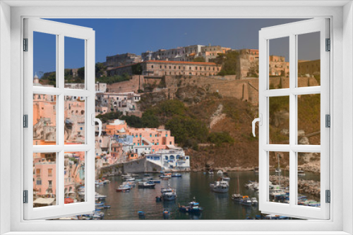 Fototapeta Naklejka Na Ścianę Okno 3D - Panoramic view of beautiful Procida on a sunny summer day. Colorful cafes, houses and restaurants, fishing boats and yachts, clear blue sky and the azure sea on the island of Procida, Italy. Napoli