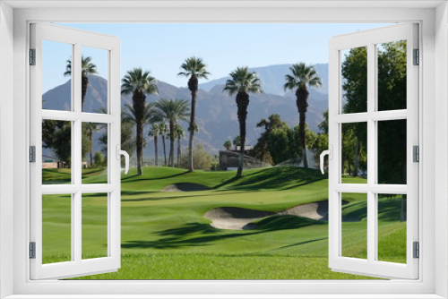 Fototapeta Naklejka Na Ścianę Okno 3D - View of desert golf course with palms and sand traps
