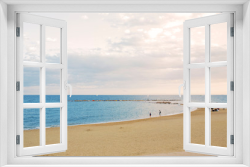 Fototapeta Naklejka Na Ścianę Okno 3D - View of Barcelona beach, in the Barceloneta district, overlooking the Mediterranean Sea. The sky is dark and there are many waves.