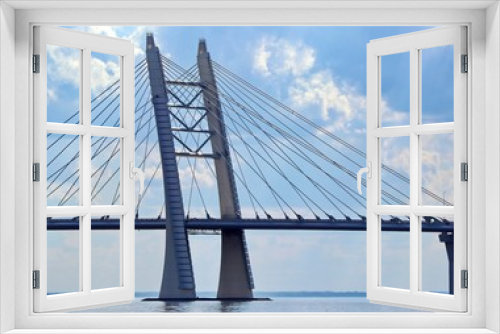 Fototapeta Naklejka Na Ścianę Okno 3D - prop of the cable bridge across the river against the background of clouds