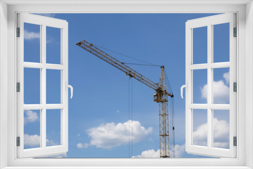 Industrial construction building crane and big clouds