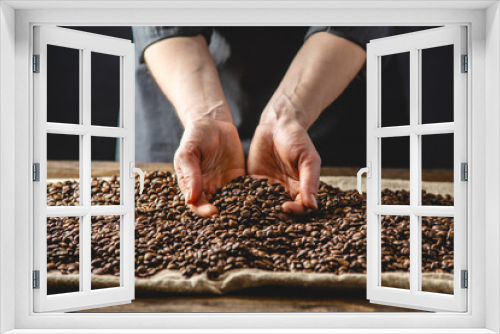 Fototapeta Naklejka Na Ścianę Okno 3D - Hands holding fragrant coffee beans. A pile of roasted Arabica grains. Selection of fresh coffee for espresso