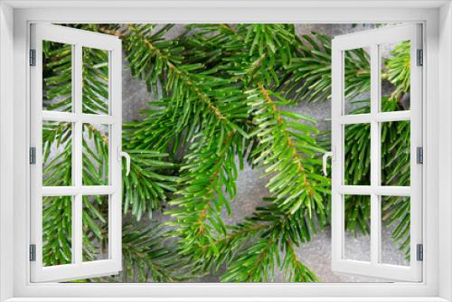 Fototapeta Naklejka Na Ścianę Okno 3D - Christmas motif, texture, background with branches of a Nordmann fir at the top on a dark grey marbled  background with free space for text.