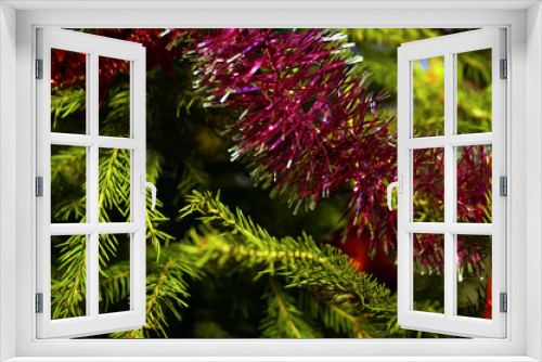 Fototapeta Naklejka Na Ścianę Okno 3D - Bright and shiny decorations for Christmas and New Year hang on a green spruce.