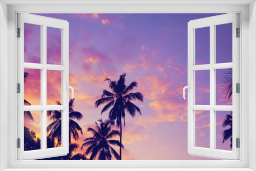 Fototapeta Naklejka Na Ścianę Okno 3D - Dark silhouettes of coconut palm trees against colorful sunset  sky on tropical island. Vacation and exotic travel concept background.