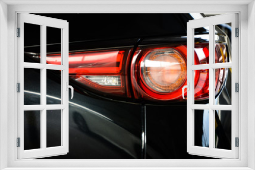 Fototapeta Naklejka Na Ścianę Okno 3D - Modern luxury car close-up banner background,Concept of expensive, sports auto,Car back lights shining in the dark,headlight of modern prestigious car closeup.