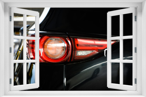 Fototapeta Naklejka Na Ścianę Okno 3D - Modern luxury car close-up banner background,Concept of expensive, sports auto,Car back lights shining in the dark,headlight of modern prestigious car closeup.