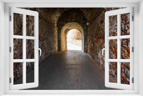 Fototapeta Naklejka Na Ścianę Okno 3D - Old brick archway as a passage between the two wings of a medieval castle