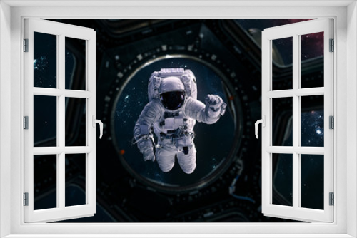 Fototapeta Naklejka Na Ścianę Okno 3D - Astronaut overboard a spaceship. View from porthole. Science fiction. Elements of this image furnished by NASA