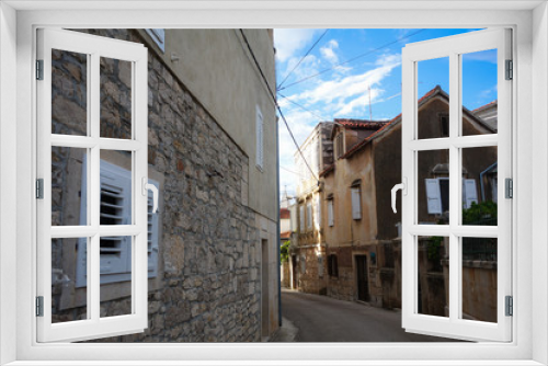 Fototapeta Naklejka Na Ścianę Okno 3D - Supetar, Croatia / June 27th 2018: Stone houses and narrow streets in old town Supetar, Brac Island. Croatia, Europe