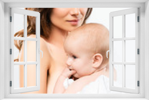 portrait of happy naked mother hugging baby boy, isolated on white