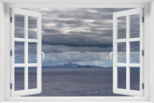 Fototapeta Naklejka Na Ścianę Okno 3D - Heavy clouds over Portuguese island Porto Santo northeast of Madeira in Atlantic Ocean during sunrise in the autumn. Rocky volcanic coastline seen from Sao Lourenco peninsula.