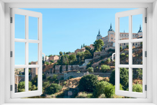 view from the river bank on the fortress wall and castles of the ancient Spanish city of Toledo