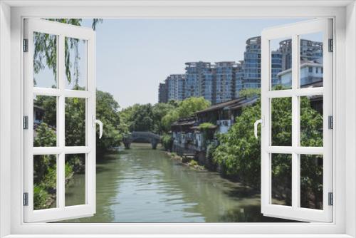 Fototapeta Naklejka Na Ścianę Okno 3D - Buildings by river in Hangzhou, China