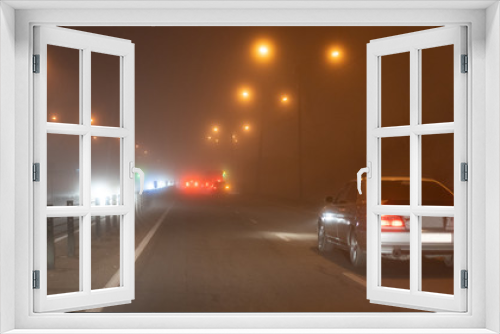 Fototapeta Naklejka Na Ścianę Okno 3D - Cars ride in the fog at night