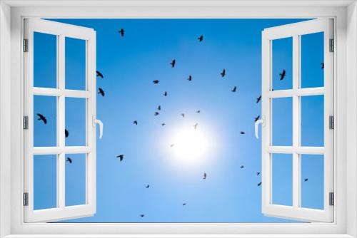 Fototapeta Naklejka Na Ścianę Okno 3D - Silhouette of a flock of blackbird flying through a surreal even