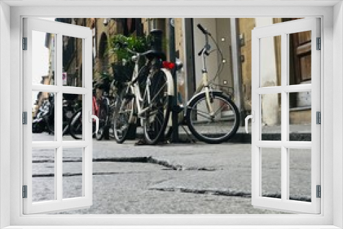 Fototapeta Naklejka Na Ścianę Okno 3D - Low angle of bicycles parked on the narrow streets of Rome
