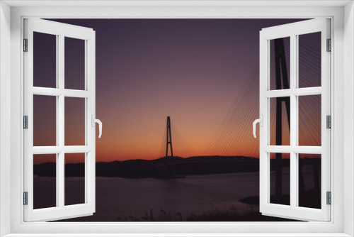 Fototapeta Naklejka Na Ścianę Okno 3D - Sea landscape with a view of the Russian bridge at sunset.