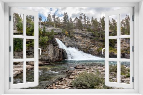 Fototapeta Naklejka Na Ścianę Okno 3D - Scenic waterfall on river in mountains of Norway with rocky wall and pine trees, wild nature northern landscape