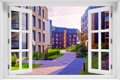 Fototapeta Naklejka Na Ścianę Okno 3D - Apartment in residential building exterior. Housing structure at blue modern house of Europe. Rental home in city district on summer. Wall and glass high architecture for business property investment.