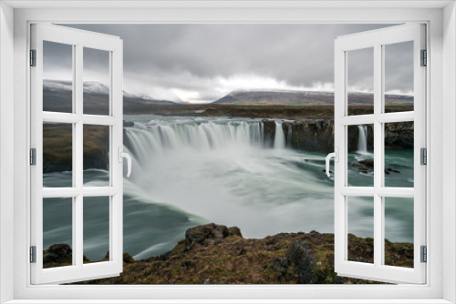 Fototapeta Naklejka Na Ścianę Okno 3D - Panorama of Godafoss waterfall near Akureyri in the Icelandic highlands. Dramatic clouds and snow covered mountains in the back. icelandic and traveling concept.