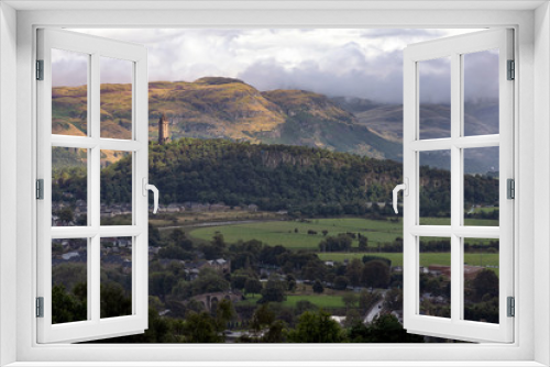 Fototapeta Naklejka Na Ścianę Okno 3D - View of The National Wallace Monument and surroundings in Stirling, Scotland. The tower standing on the shoulder of the Abbey Craig, and commemorates Sir William Wallace, a 13th-century Scottish hero