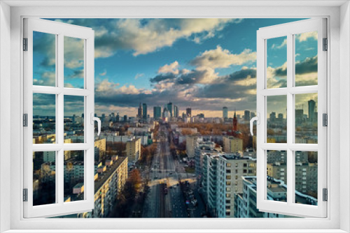 Fototapeta Naklejka Na Ścianę Okno 3D - Beautiful panoramic aerial drone view to the Сenter of modern Warsaw city with silhouettes of skyscrapers in in the rays of the setting winter January sun - amazing sunset, Poland