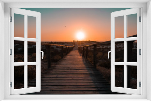 Fototapeta Naklejka Na Ścianę Okno 3D - Wooden walkway towards sunset