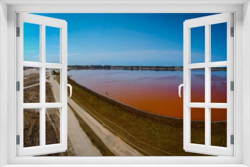 Fototapeta Naklejka Na Ścianę Okno 3D - Aerial view of Lac Rose or Lake Retba in Senegal. Pink lake showing natural beauty and rich color on a sunny day. View of lake coastline and atlantic in the background.