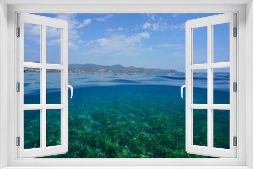 Fototapeta Naklejka Na Ścianę Okno 3D - Mediterranean seascape, coastline with cloudy blue sky and seabed covered by Posidonia oceanica sea grass underwater, split view over and under water surface, Costa Brava, Catalonia