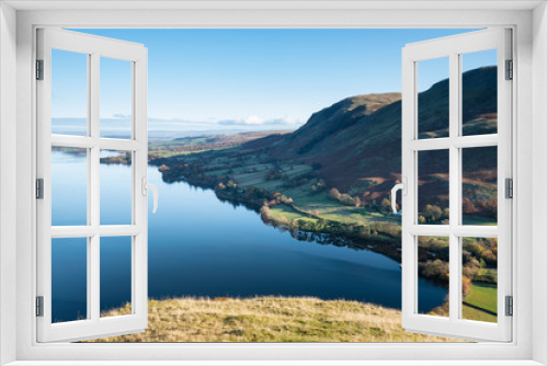 Fototapeta Naklejka Na Ścianę Okno 3D - Beautiful Autumn Fall landscape of Ullswater and surrounding mountains and hills viewed from Hallin Fell on a crisp cold morning with majestic sunlgiht on the hillsides