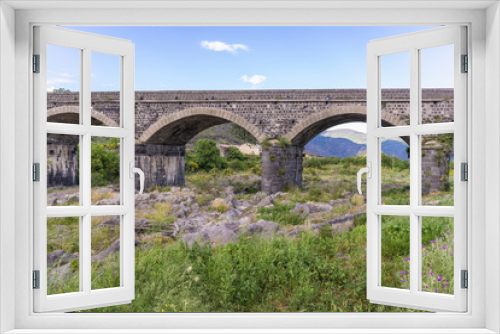 Fototapeta Naklejka Na Ścianę Okno 3D - Old stone bridge over River Alcantara near Castiglione di Sicilia village, Sicily in Italy