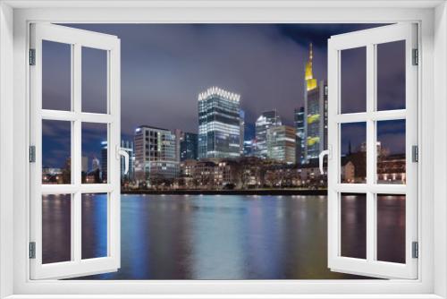 Fototapeta Naklejka Na Ścianę Okno 3D - The Skyline of Frankfurt by night, seen from the river Main.