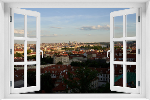 Fototapeta Naklejka Na Ścianę Okno 3D - Typical roofs. Top view - roofs with red tiles in old buildings. There are beautiful houses in green trees. Horizontal photo colorful European city Prague in Czech Republic, travel in tourist place