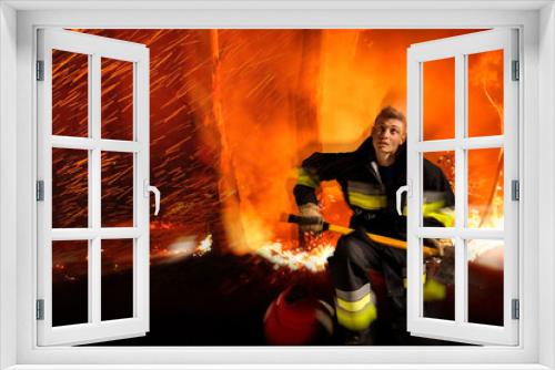 Fototapeta Naklejka Na Ścianę Okno 3D - Equipped firefighter is in fire, life threatening, flames in forest space.