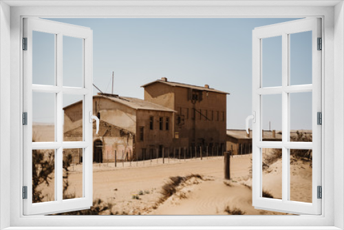 Fototapeta Naklejka Na Ścianę Okno 3D - home ruins in the African desert sunk in sand