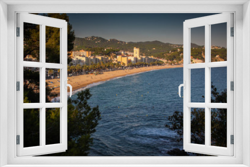 Fototapeta Naklejka Na Ścianę Okno 3D - Panorama of beach in Tossa de Mar, close to Lloret de mar in Catalunya, Waves and sandy beach with city in the background are visible.