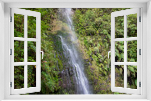 Fototapeta Naklejka Na Ścianę Okno 3D - Waterfall beside the hiking trail on the Levada Caldeirao Verde near Santana on the island of Madeira, Portugal.